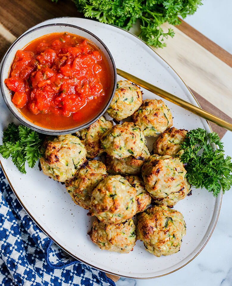 Chicken and zucchini meatballs served with marinara sauce.