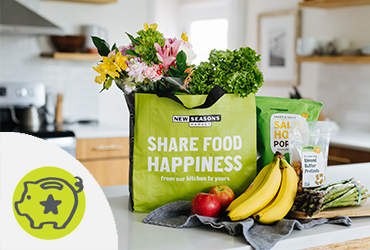 Reusable grocery bag on counter with illustrated piggy bank icon.