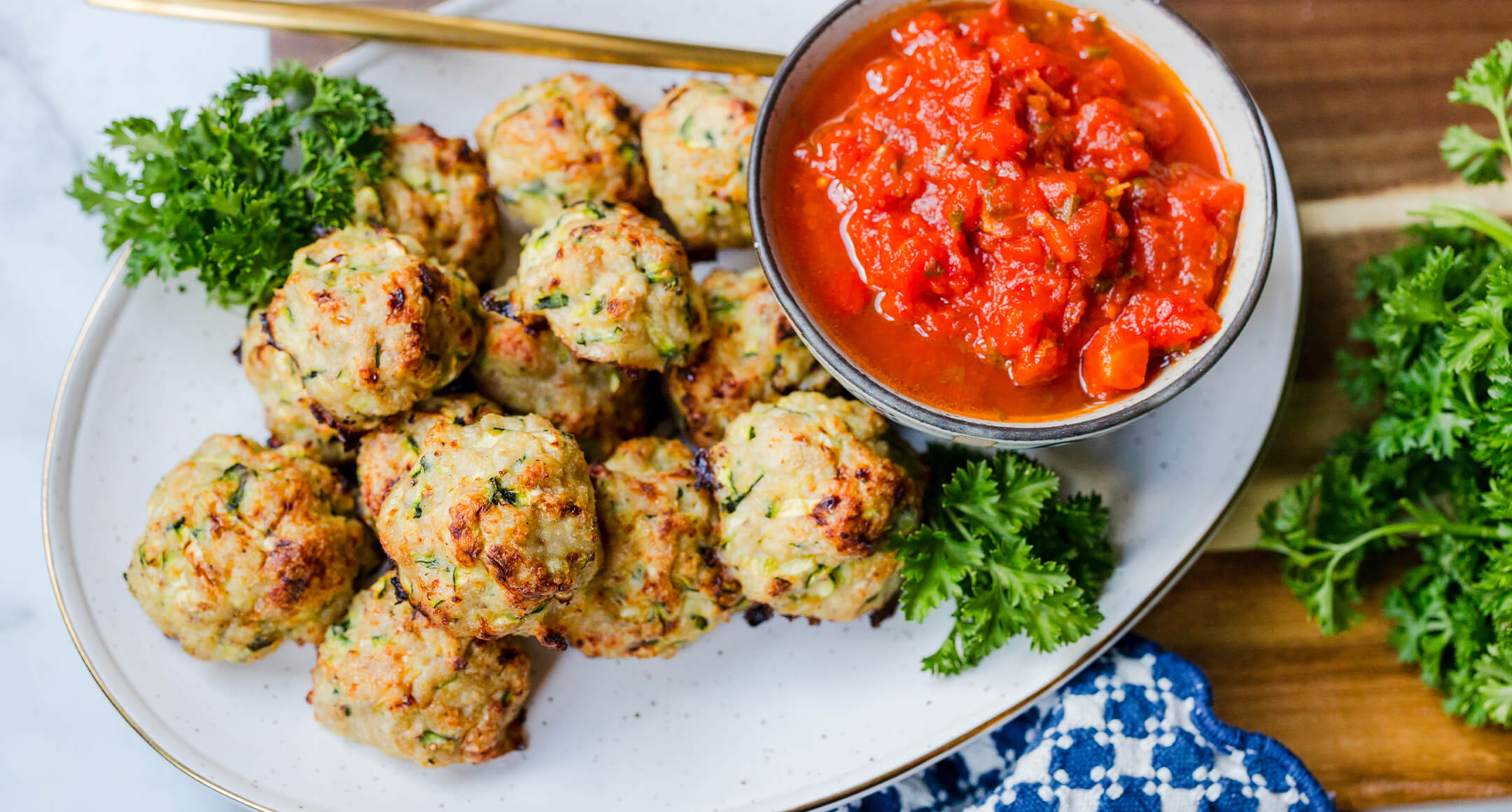 Chicken and zucchini meatballs served with marinara sauce.