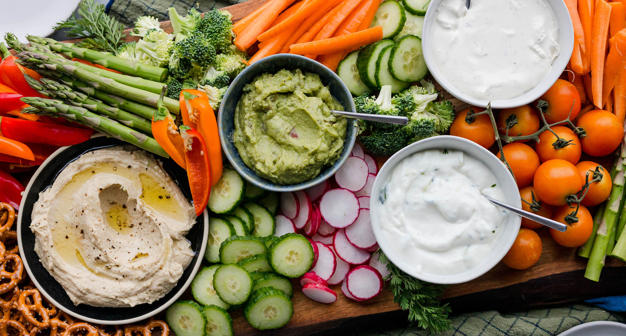 Crudite platter featuring fresh veggies, pretzels and dips.