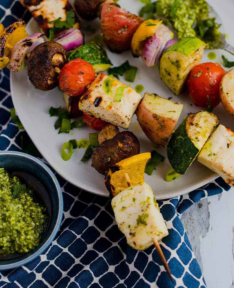 grilled vegetable and haloumi cheese skewers on a plate.