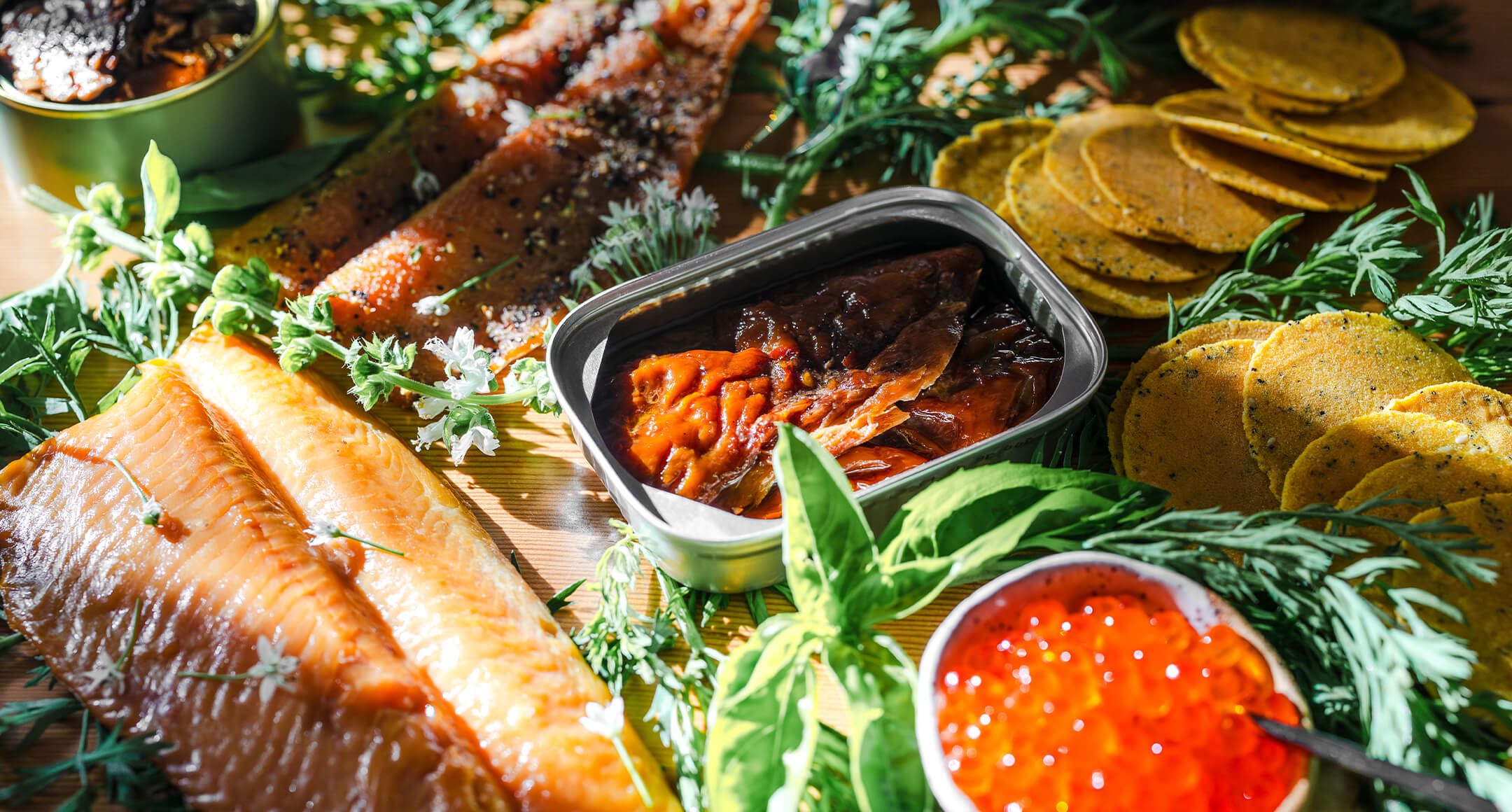 A sea-cuterie board with smoked fish, trout roe, and tinned fish.