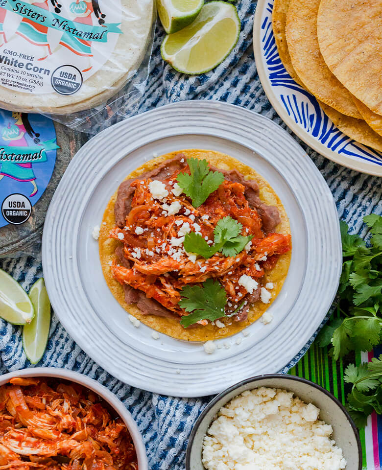 Chicken tinga tostada on a plate