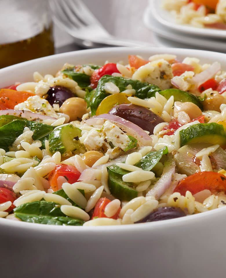 Greek Orzo salad with tomato, cucumber, red onion, and olives.