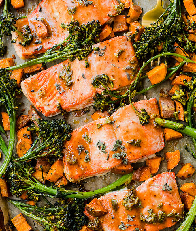 salmon fillets with broccolini on a sheetpan.