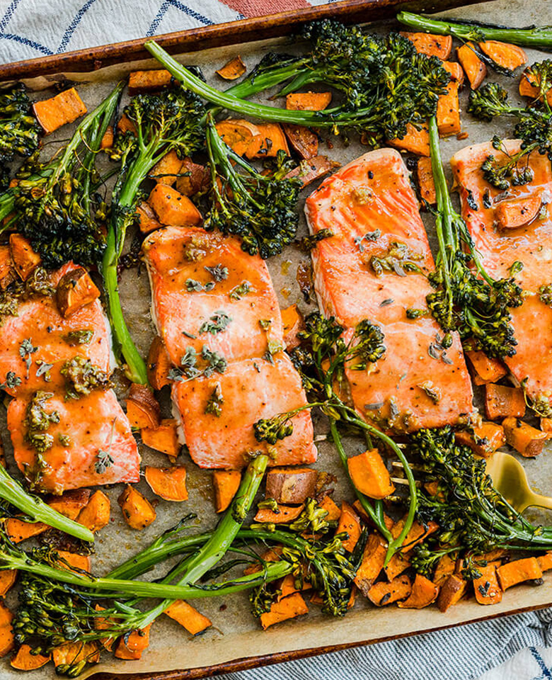 Salmon, broccoli and sweet potatoes roasted on a sheet pan.