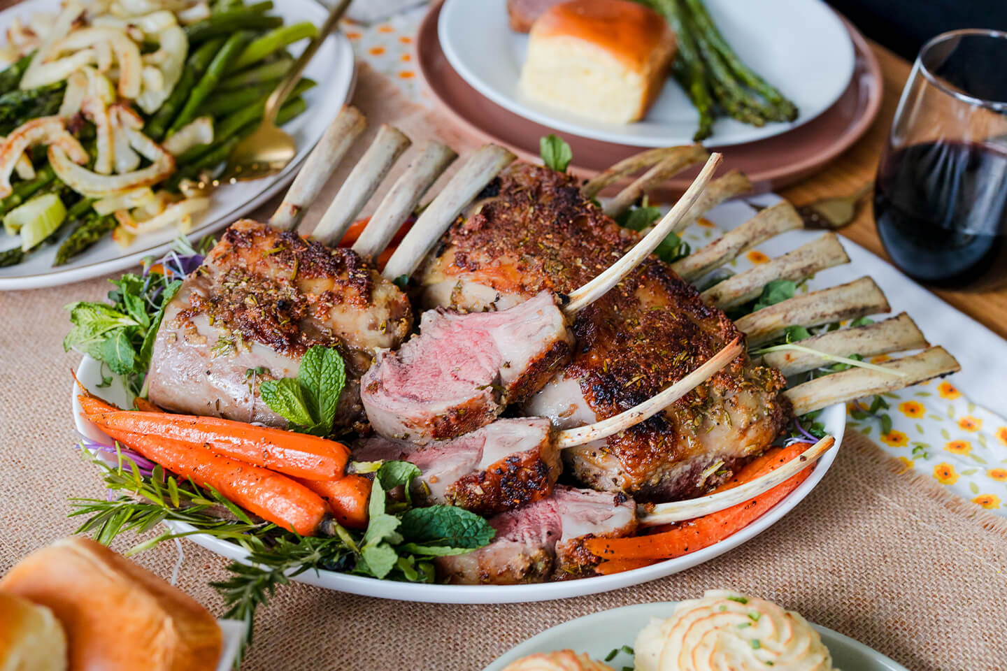 a festive platter with lamb, carrots, mashed potatoes and other sides.