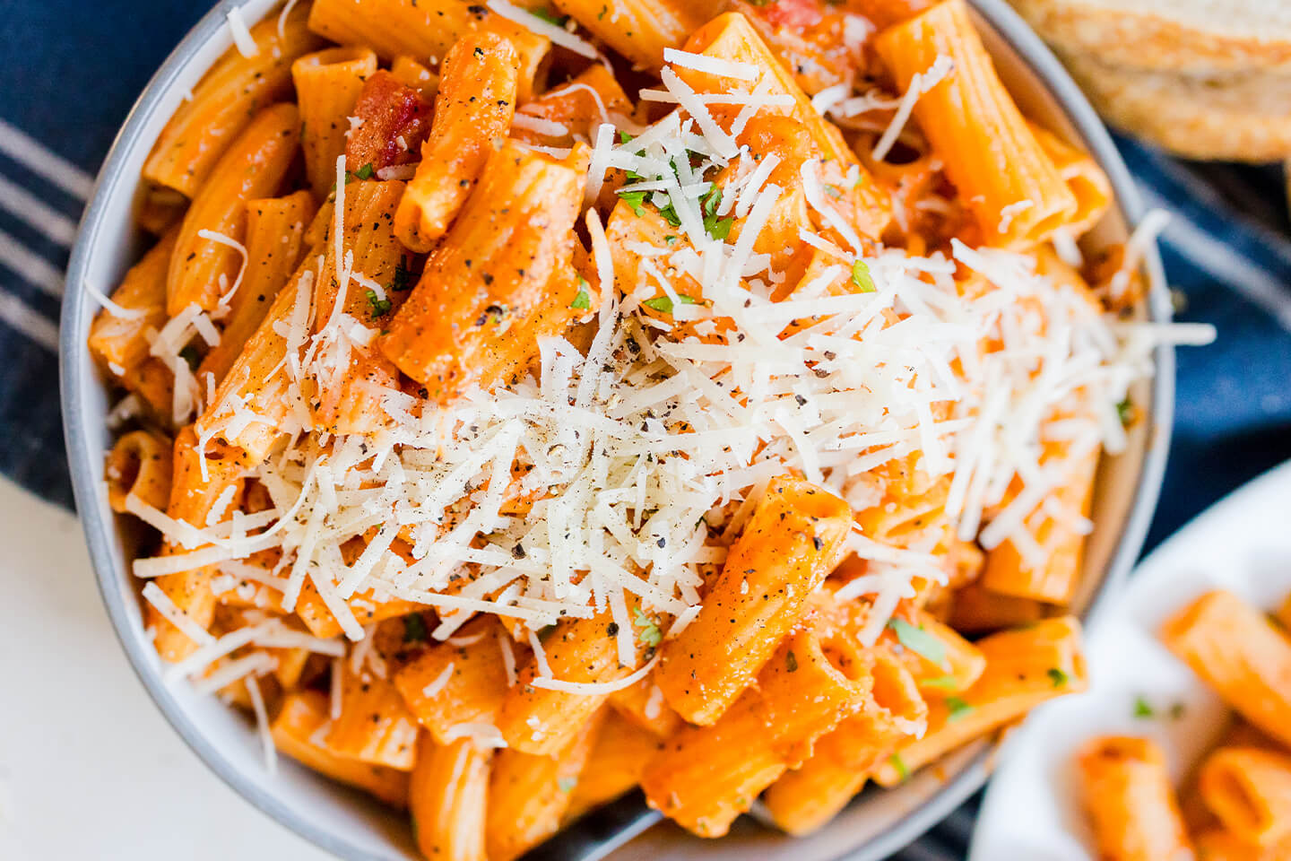 Rigatoni pasta tossed with red sauce and topped with shredded parmesan.