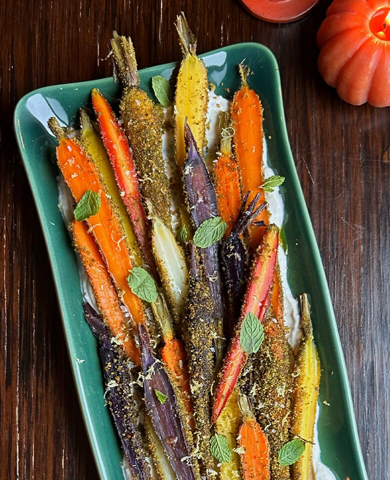 Pistachio Herb-Crusted Carrots over Spiced Yogurt