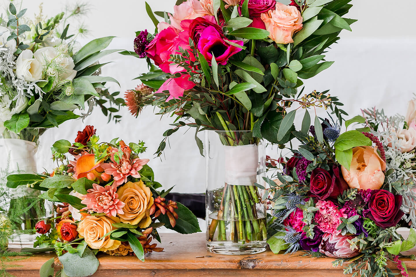 New Seasons wedding floral arrangements, including four colorful bouquets.